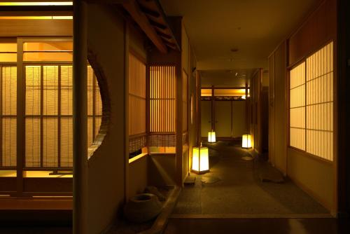 a hallway of a building with windows and lights at Hotel Sakurai in Kusatsu