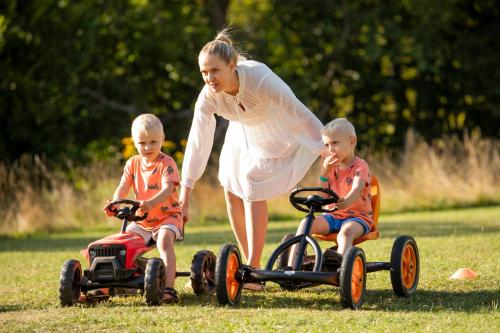 a woman and two children playing with toy trucks at Chata Belez in Dolný Kubín