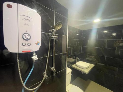 a bathroom with a shower with a toilet and a shower at Hidden Gem @ Marina View Villas PD in Port Dickson