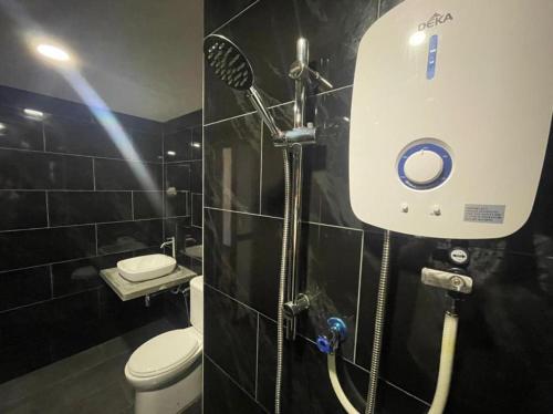 a shower in a bathroom with a toilet at Hidden Gem @ Marina View Villas PD in Port Dickson
