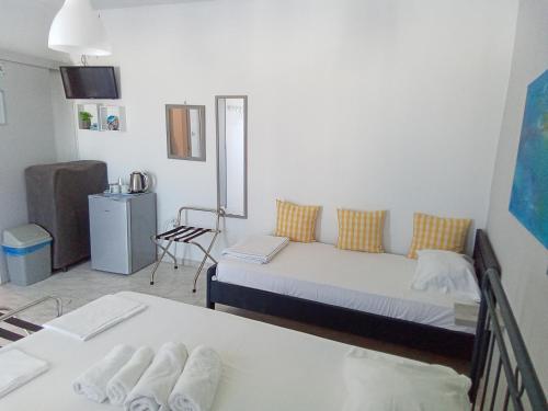 a small room with two beds and a table at Sunloft-Paros in Naousa