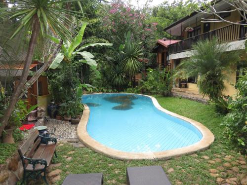 a swimming pool in the yard of a resort at Little Eden Guesthouse in Pang Mapha