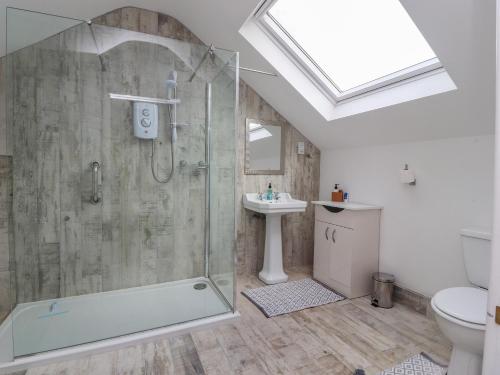a bathroom with a shower and a toilet and a sink at Sea La Vie in Lytham St Annes