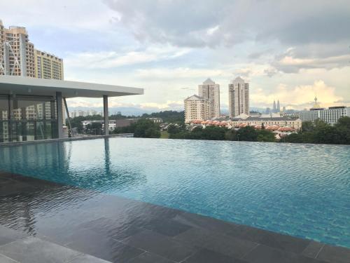 una piscina en la azotea de un edificio con ciudad en The Signature Hotel & Serviced Suites Kuala Lumpur en Kuala Lumpur