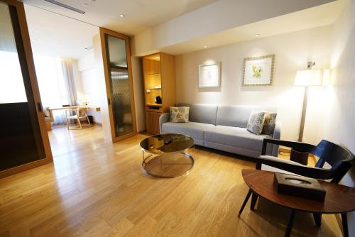 a living room with a couch and a table at Chiayi Maison de Chine Hotel in Chiayi City