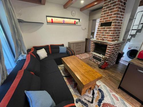 a living room with a couch and a fireplace at Chata Miško in Snina
