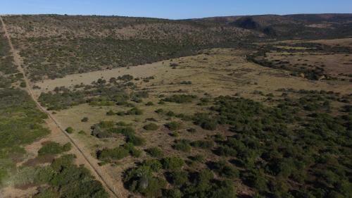 an aerial view of a field with trees and a road at Pure Nature Familodge in Paterson