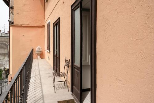 two chairs sitting on the balcony of a building at Al Duomo in Lonato del Garda