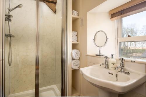 a bathroom with a sink and a shower at Shepherds Retreat in Hexham