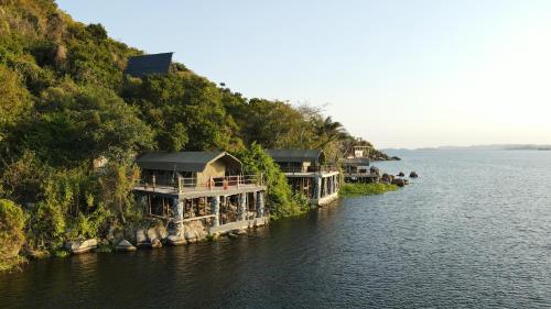 a row of houses on an island in the water at Wag Hill Lodge & Spa in Mwanza