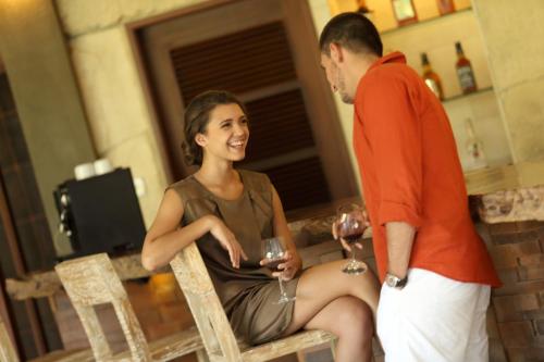 a man and a woman holding glasses of wine at Alindra Villas & Spa in Nusa Dua