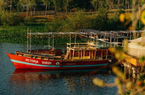 a red boat is sitting in the water at Wag Hill Lodge & Spa in Mwanza