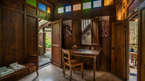 a wooden room with a desk and a chair at Yabbiekayu Eco-Bungalows in Yogyakarta