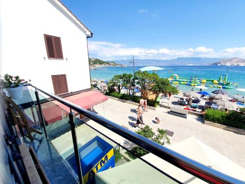 a balcony of a building with a view of the water at Apartments Toni in Baška