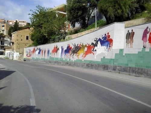 a wall with a painting of horses on it at THE PALACE B&B and Apartments in Santo Stefano di Camastra