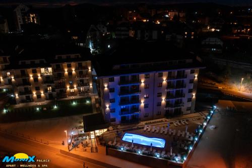 a building with a blue light on it at night at Monix Palace Zlatibor in Zlatibor
