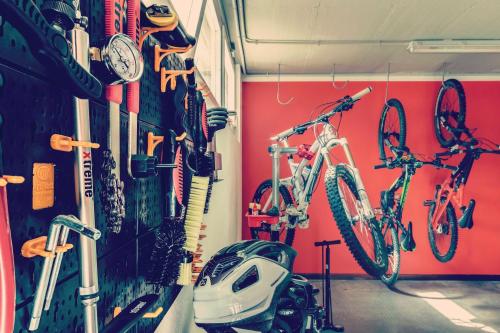 a garage with two bikes hanging on a wall at Hotel Tremoggia in Chiesa in Valmalenco