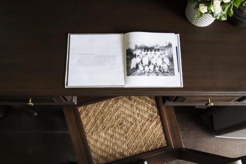 a book sitting on top of a wooden table at Baan Luang Rajamaitri Historic Inn in Chanthaburi