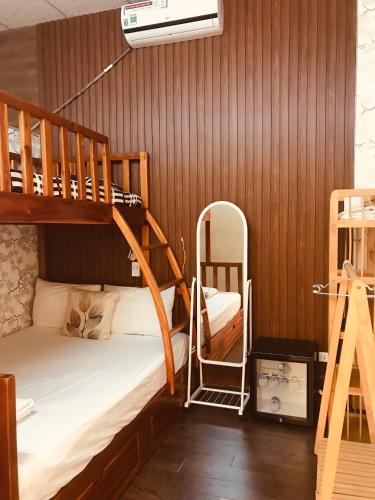 a bedroom with two bunk beds and a mirror at Khang Homestay in Danang