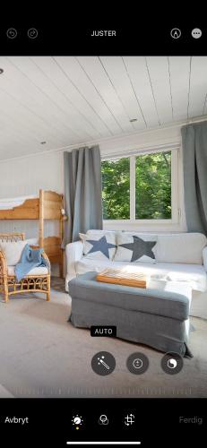 a bedroom with two beds and a couch at Kragerø hytte havsutsikt in Kragerø