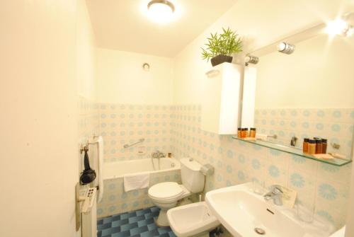 une salle de bain avec des toilettes blanches et un lavabo dans l'établissement antares57, à Cannes