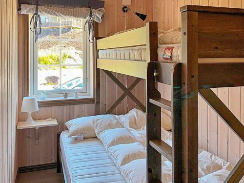 a bedroom with two bunk beds and a window at 10 person holiday home in Rauland-By Traum in Rauland