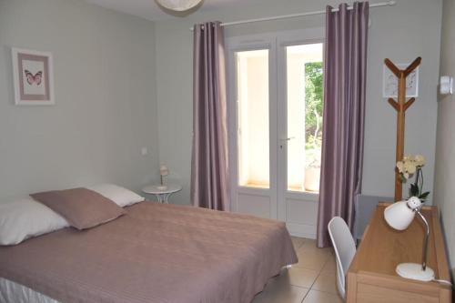 - une chambre avec un lit, une table et une fenêtre dans l'établissement Appartement charmant en Corse avec terrasse au calme, à Santa-Lucia-di-Moriani