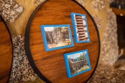 a wooden plate with pictures on it at Gerês Country Stays - Lagar in Rio Caldo