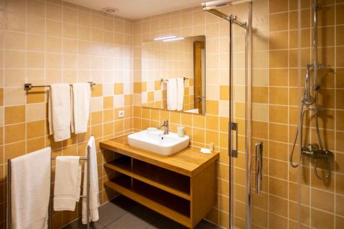 a bathroom with a sink and a shower at Gerês Country Stays - Lagar in Rio Caldo