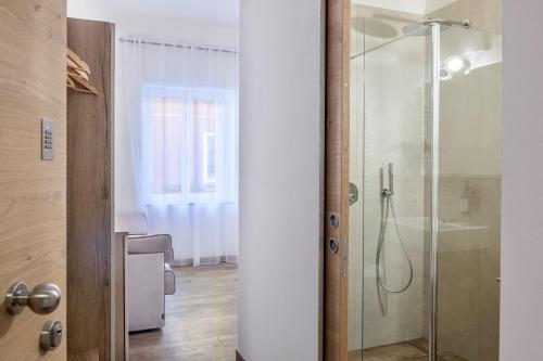 Un baño con ducha con puerta de cristal. en Apartment Isabel, en Bolzano