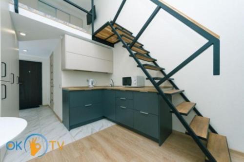 a kitchen with a spiral staircase in a loft at Smart House 7 in Kyiv