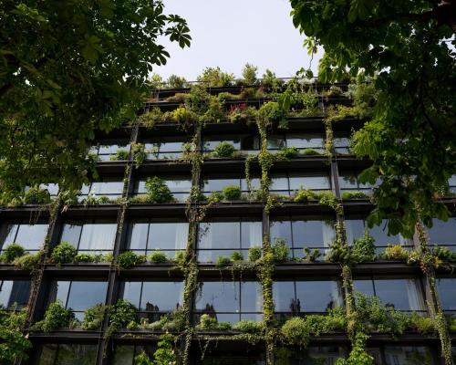 an office building with plants on the facade at Villa M in Paris