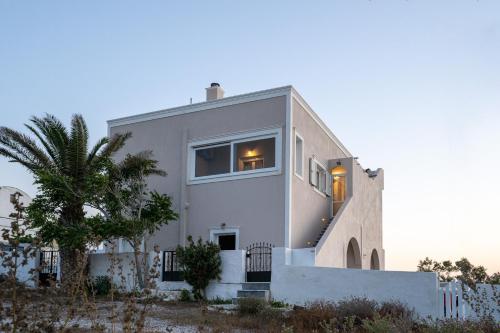 a white house with lights in the window at Amarie House with Sea View & Sunset View in Oia