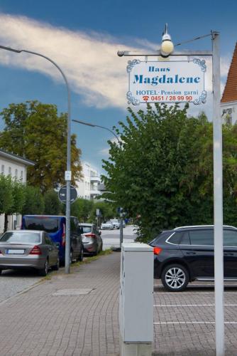 a street sign with cars parked in a parking lot at Haus Magdalene in Bad Schwartau