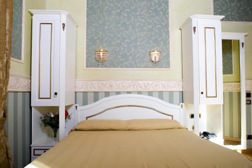 a bedroom with a bed with a white canopy at Upper View Suite in Rome