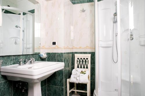 a bathroom with a sink and a shower at Upper View Suite in Rome