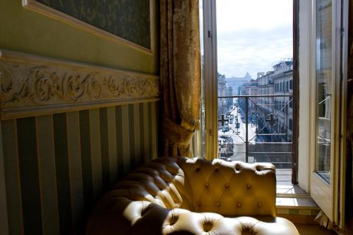 a couch in a room with a large window at Upper View Suite in Rome