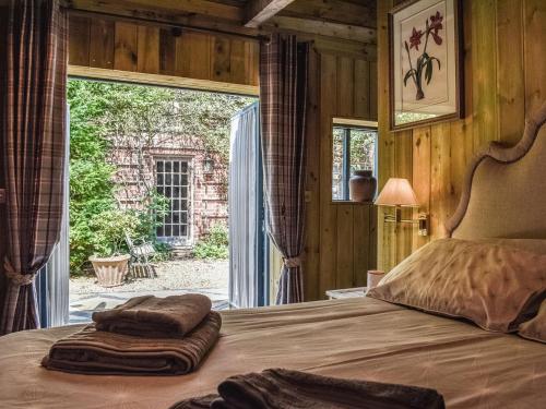 a bedroom with a bed with two towels on it at The Potting Shed in Huntingdon