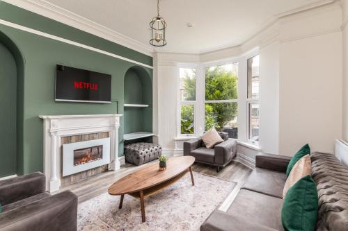 a living room with a couch and a fireplace at Stunning Skipton House by Yorksha Property in Skipton