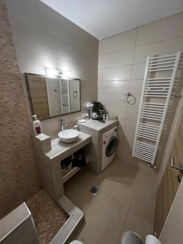 a bathroom with a sink and a washing machine at Alkistis House in Volos