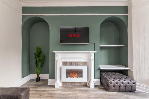 a living room with a fireplace and a tv at Stunning Skipton House by Yorksha Property in Skipton