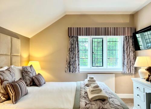 a bedroom with a bed and a window at Mallyan Spout Hotel in Goathland