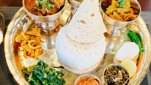 a tray filled with different types of food on a table at Hotel Grand View in Kathmandu
