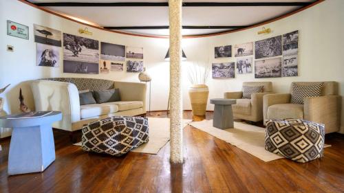 a living room with couches and a table at Olare Mara Kempinski in Talek
