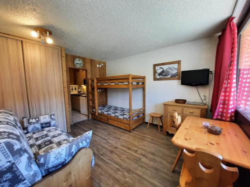 - un salon avec un canapé et des lits superposés dans l'établissement Studio Confort pour 3 avec Balcon Sud, Pied des Pistes, Animaux Acceptés - FR-1-452-289, aux Menuires