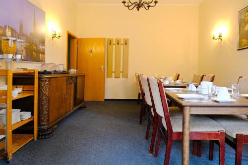 a dining room with a wooden table and chairs at Haus Magdalene in Bad Schwartau
