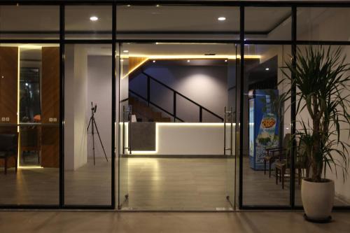 an open glass door with a staircase in a building at Rahayu Hotel Cirebon in Cirebon