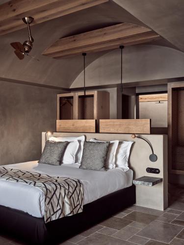 a bedroom with a large bed in a room at Acro Suites - A Wellbeing Resort in Agia Pelagia
