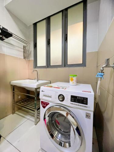 a washing machine in a bathroom with a sink at Maison life 小居屋 The Loft Imago in Kota Kinabalu