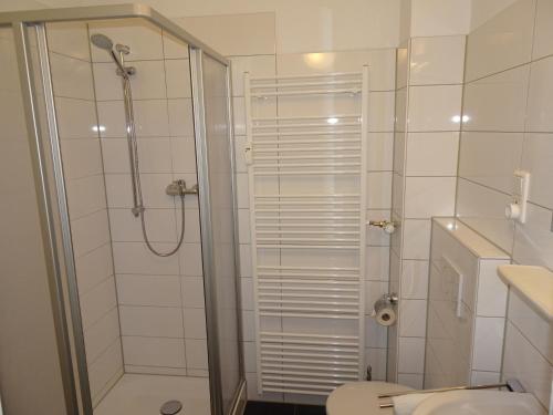 a bathroom with a shower and a toilet at Gästehaus Grupello in Düsseldorf